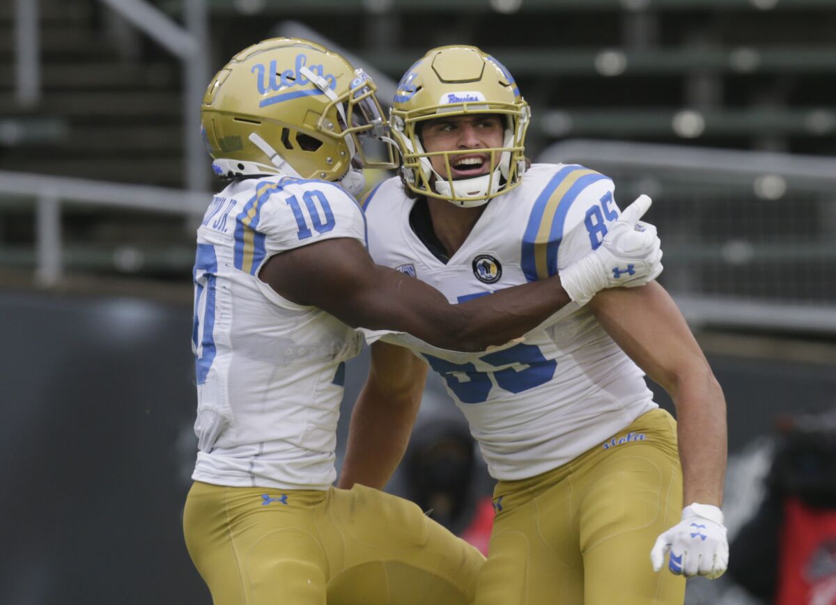 UCLA's Demetric Felton and Greg Dulcich celebrate a touchdown against Oregon on Saturday.