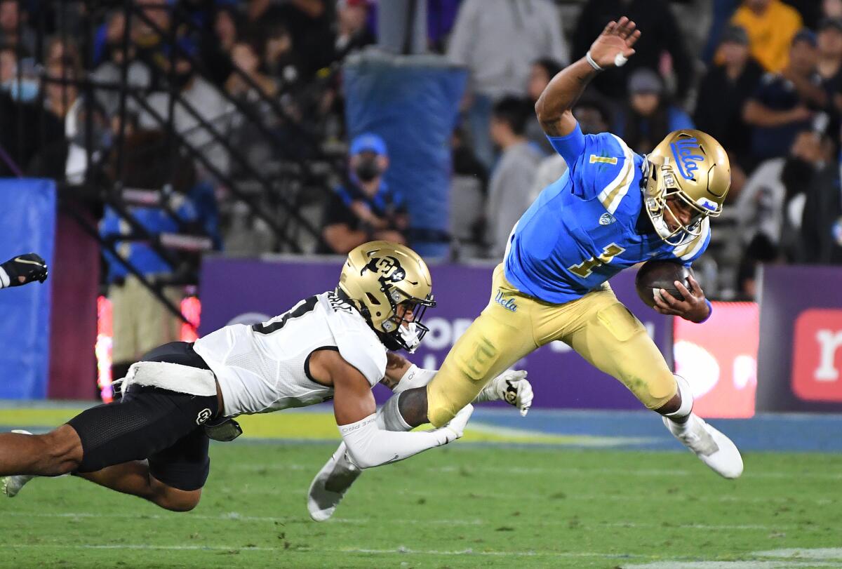 UCLA quarterback Dorian Thompson-Robinson is brought down by Colorado cornerback Christian Gonzalez.