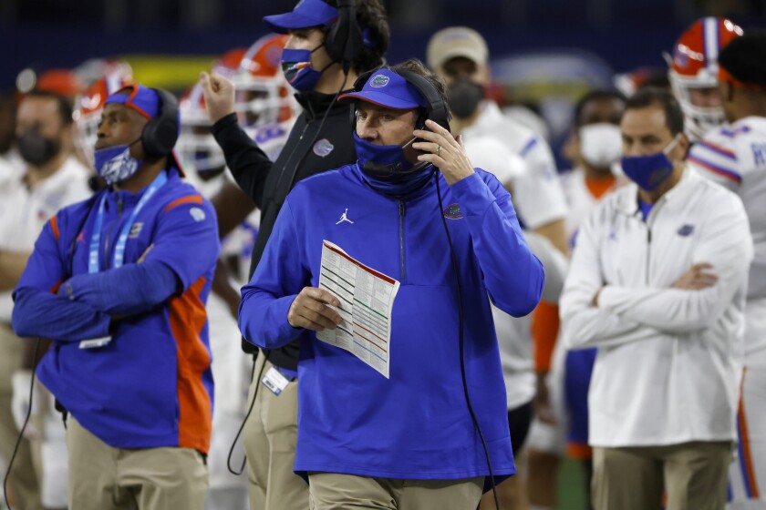 Florida coach Dan Mullen, center, watches play against Oklahoma during the first half of the Cotton Bowl NCAA college football game in Arlington, Texas, Wednesday, Dec. 30, 2020. (AP Photo/Ron Jenkins)