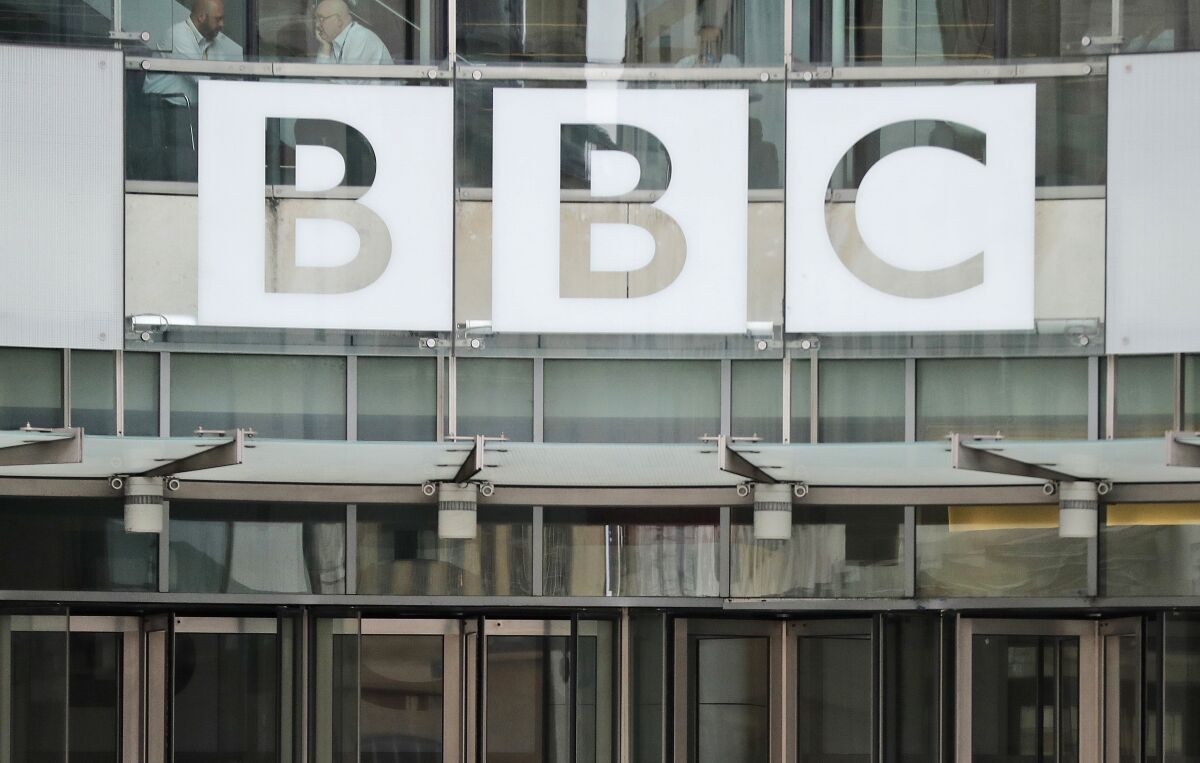 FILE - The BBC sign outside the entrance to the headquarters of the publicly funded media organisation in London