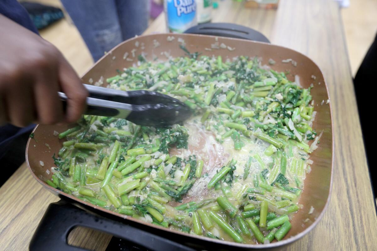Students helped stir and cook the vegetables at the Roosevelt Middle School enrichment culinary class on Thursday.