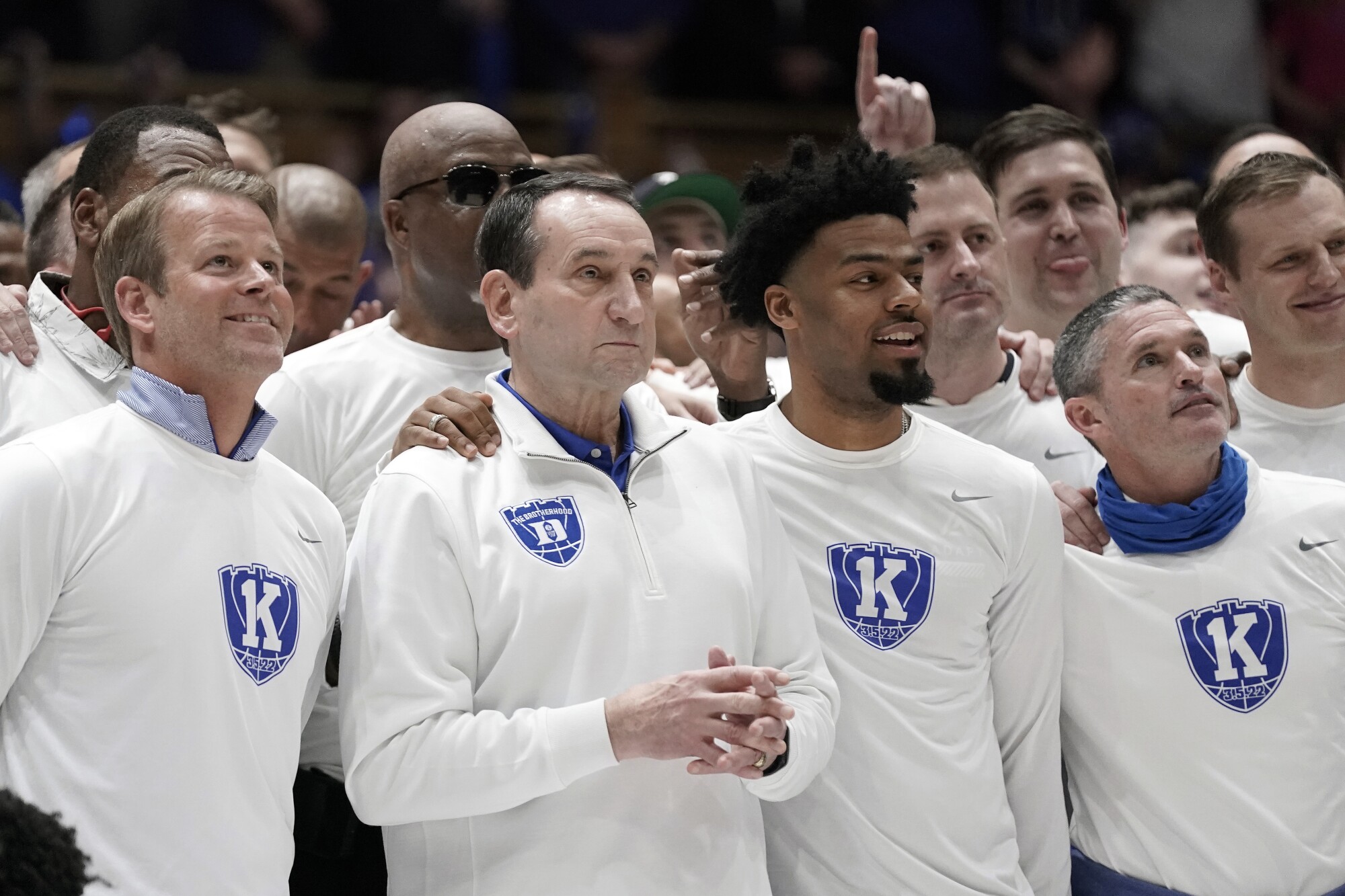 Duke coach Mike Krzyzewski, second from left, stands with his former players during a pregame ceremony Saturday.