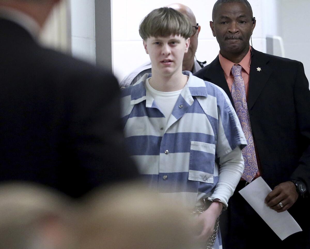 FILE - In this April 10, 2017, file photo, Dylann Roof enters the court room at the Charleston County Judicial Center to enter his guilty plea on murder charges in Charleston, S.C. A federal appeals court on Wednesday, Aug. 25, 2021, upheld Roof's conviction and sentence on federal death row for the 2015 racist slayings of nine members of a Black South Carolina congregation. A three-judge panel of the 4th U.S. Circuit Court of Appeals in Richmond affirmed Roof's conviction and sentence in the shootings at Mother Emanuel AME Church in Charleston. (Grace Beahm/The Post And Courier via AP, Pool, File)