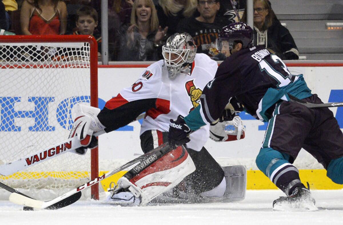 Ducks center Nick Bonino tries to get a shot off against Senators goalie Robin Lehner in the first period Sunday.