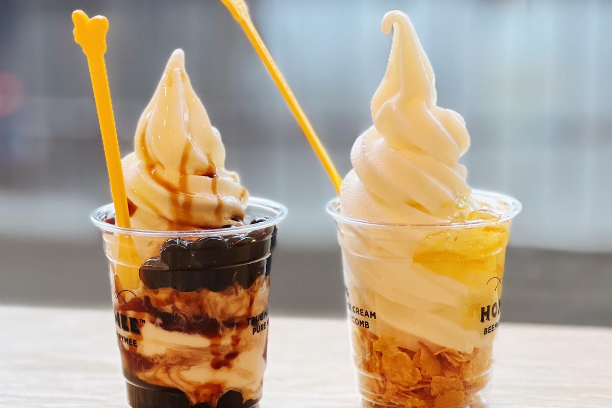 Plastic cups of brown sugar boba soft serve and yuzu affogato at Honeymee in Los Angeles.