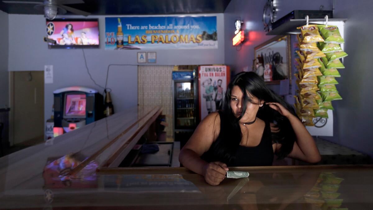 Karla Morales tends bar at the reopened Las Palomas bar on 1st Street Boyle Heights.