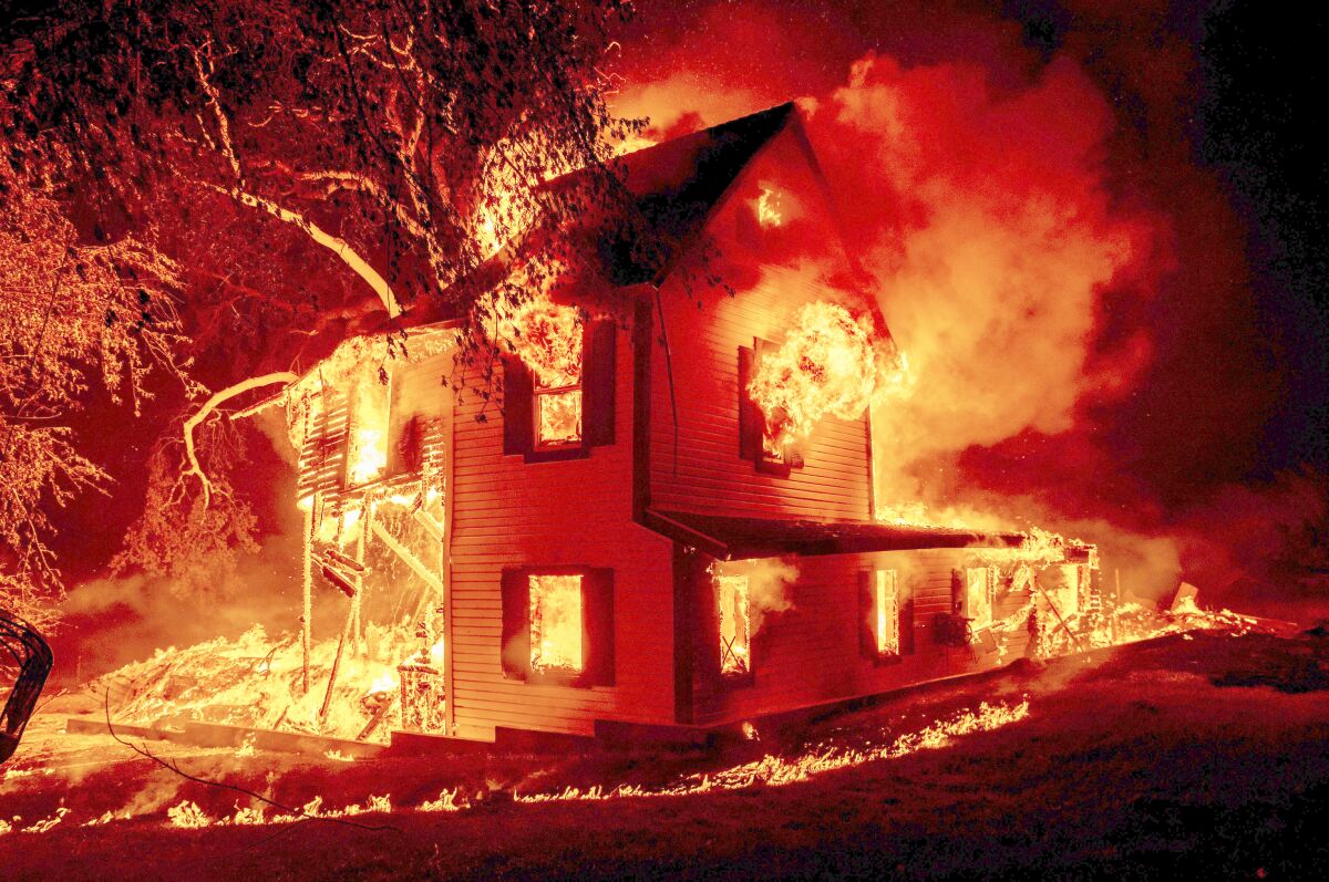 A home burns amid the Dixie fire