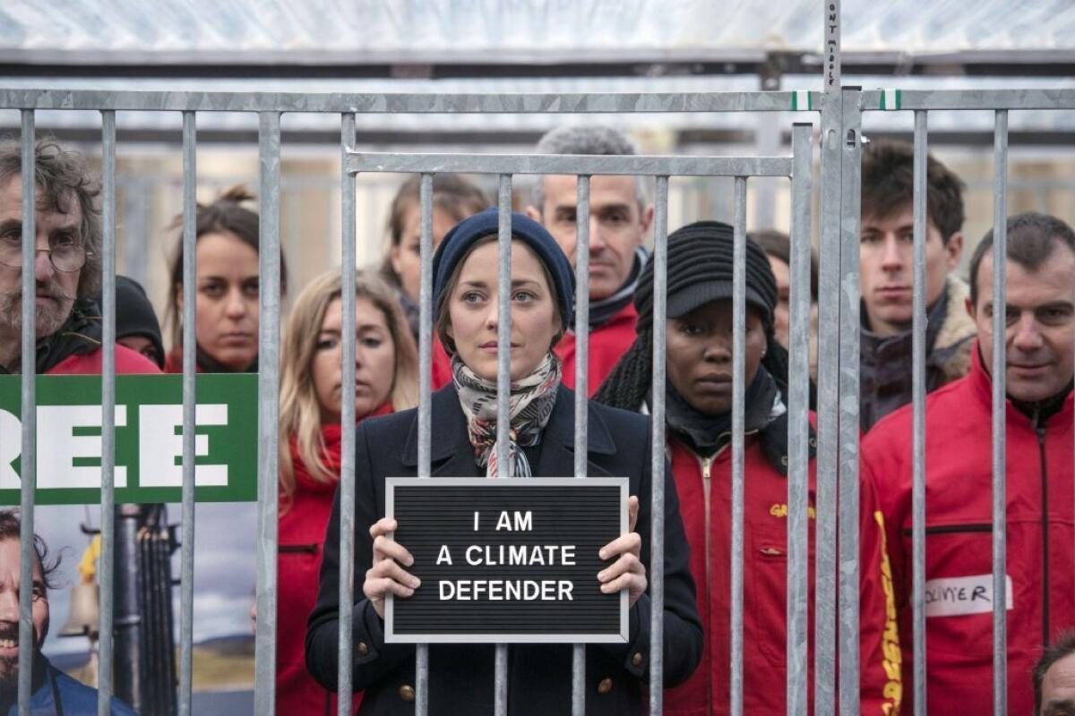 French actress Marion Cotillard stands with Greenpeace activists earlier this month in Paris.