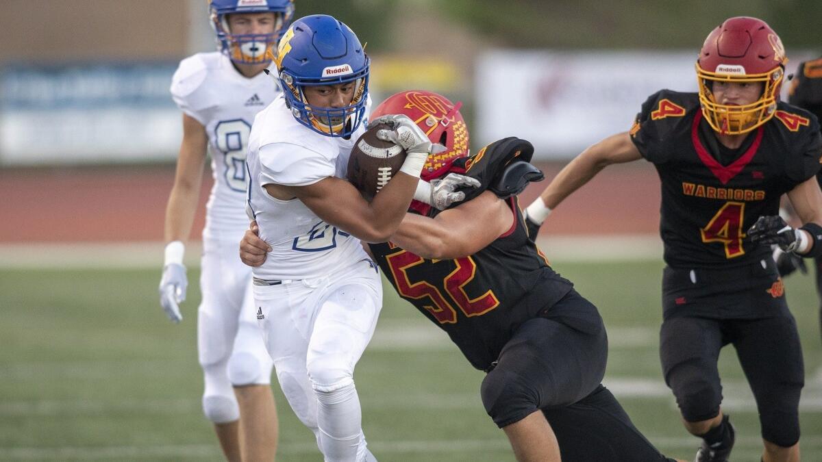 Fountain Valley High running back Mathew Fuiava, seen being tackled by Woodbridge's Jared Ayvazian on Aug. 31, has rushed for 355 yards and seven touchdowns this season.