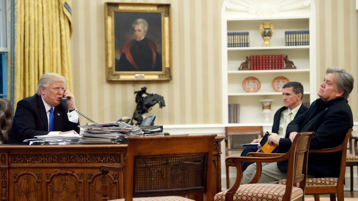 President Donald Trump with chief strategist Steve Bannon, right, and National Security Adviser Michael Flynn, center, in the Oval Office of the White House on Jan. 28.