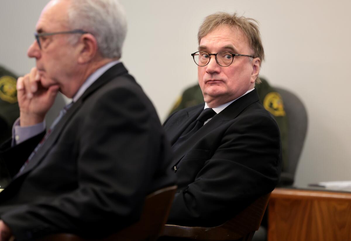 Eric Sills listens to a prosecutor during closing arguments in the murder trial of his wife.