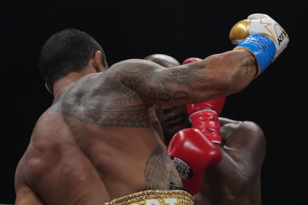 Former MMA star Vitor Belfort, left, punches former heavyweight champion Evander Holyfield during a boxing match, Saturday, Sept. 11, 2021, in Hollywood, Fla. (AP Photo/Rebecca Blackwell)