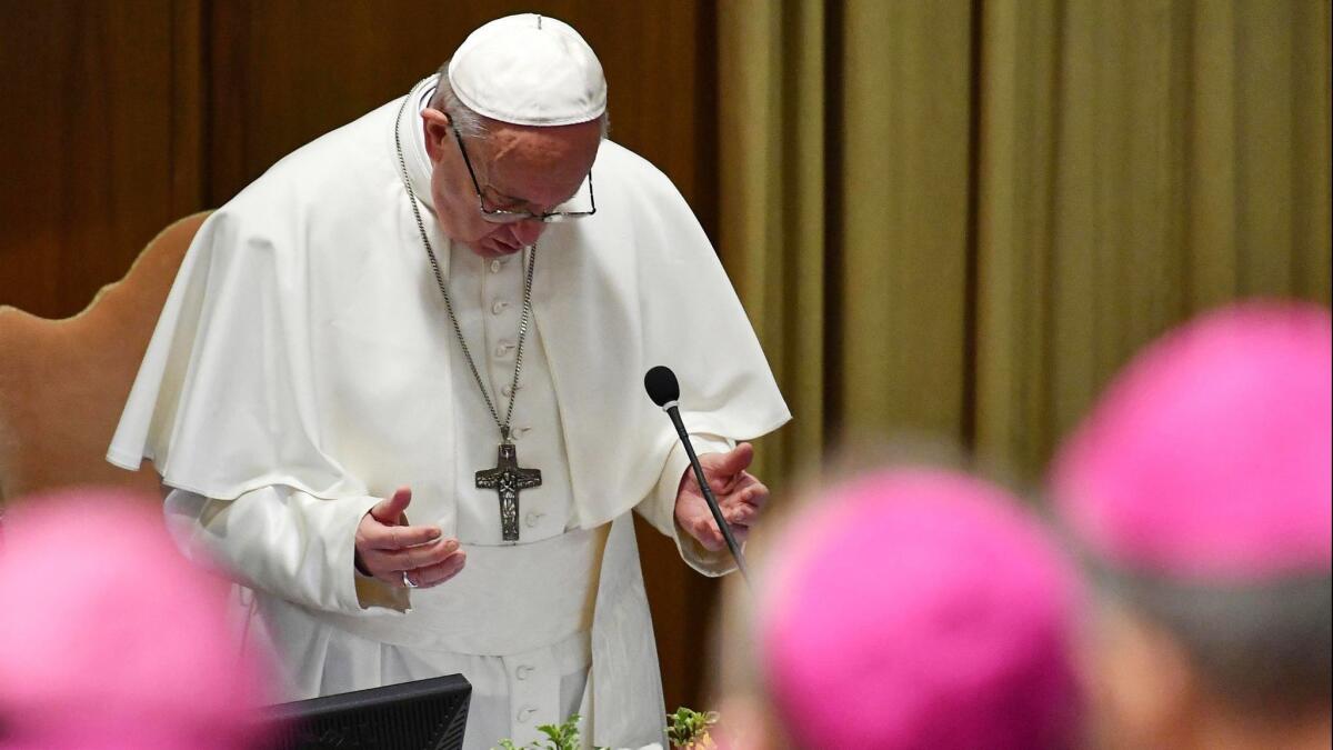 Pope Francis prays during the opening of a global child protection summit at the Vatican on Feb. 21.