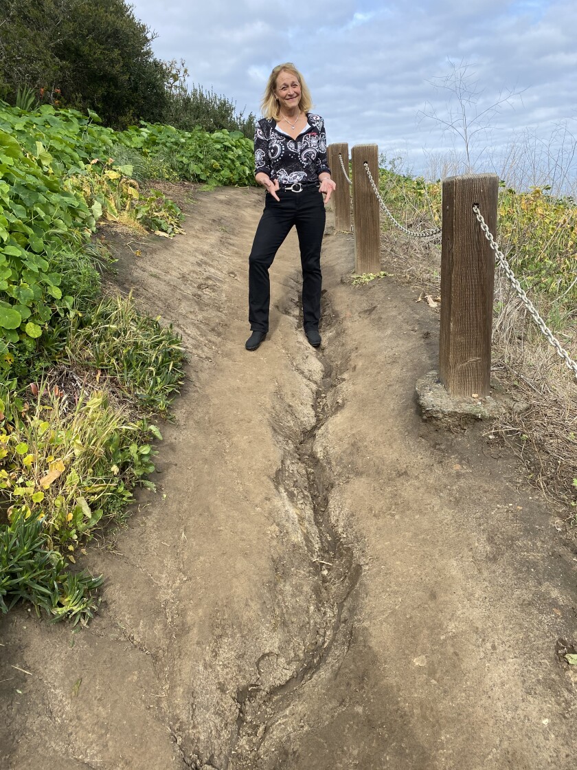 Friends of Coast Walk Trail founder Brenda Fake points out erosion along the path in La Jolla.