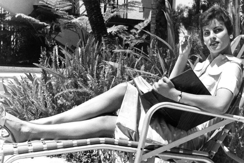 Raquel Tejada of La Jolla is shown in June 1958 relaxing in a lounge chair reading a script.