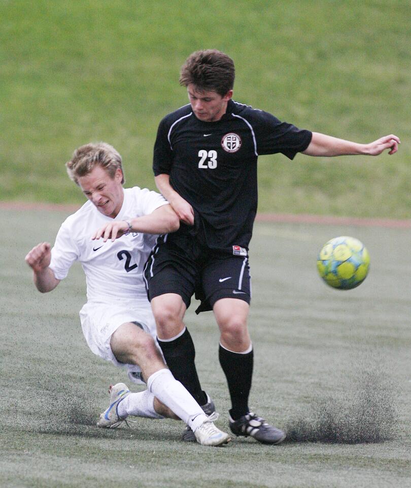 Flintridge Prep's Kurt Kozacik gets in front of Grace Brethren's Coby Larson to clear the ball in the second half in a non-league boys soccer match at the Glendale Sports Complex on Wednesday, November 28, 2012.