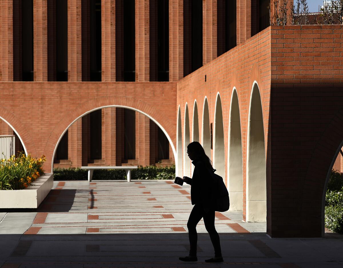 A student walks past USC's Barbara and Roger Rossier School of Education