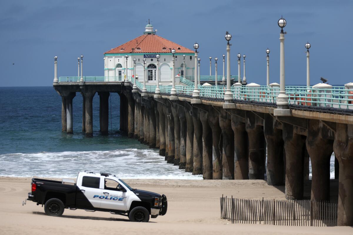Manhattan Beach police patrol near the pier on July 3.