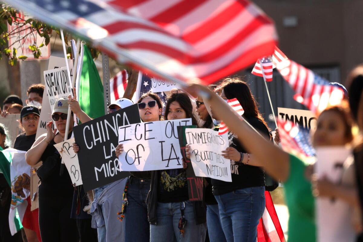 Citizens protest the recent ICE raids in the southland at the corner of Atlantic and Firestone Blvd. in South Gate on June 12