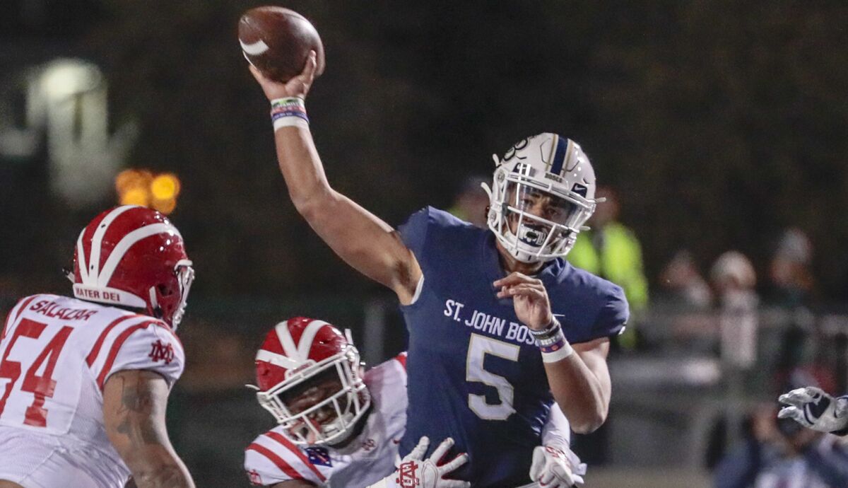 St. John Bosco aquarterback DJ Uigaleilei unloads a pass while pressured by Mater Dei on Nov. 30, 2019, during the Southern Section Divsion 1 championship game at Cerritos College.