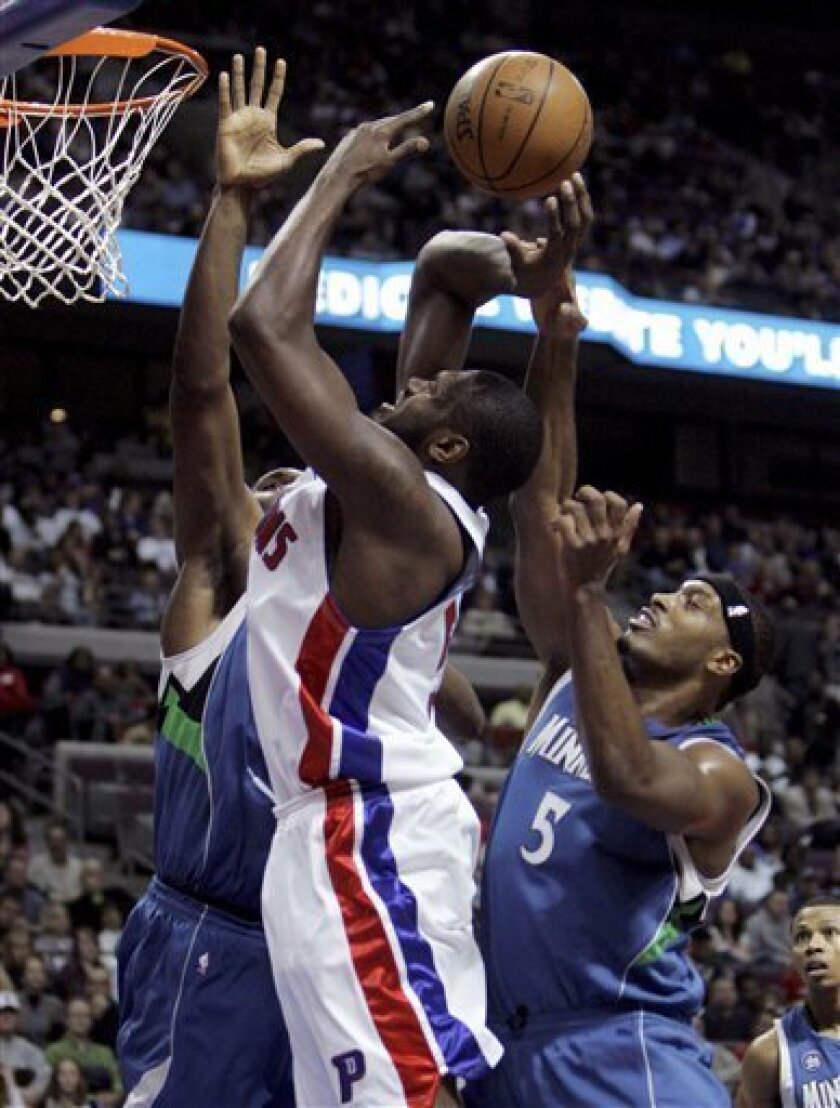 Detroit Pistons forward Jason Maxiell, center, is sandwiched by Minnesota Timberwolves forwards Al Jefferson, left, and Craig Smith (5) during the second quarter of an NBA basketball game at the Palace in Auburn Hills, Mich., Sunday, Nov. 23, 2008. (AP Photo/Carlos Osorio)