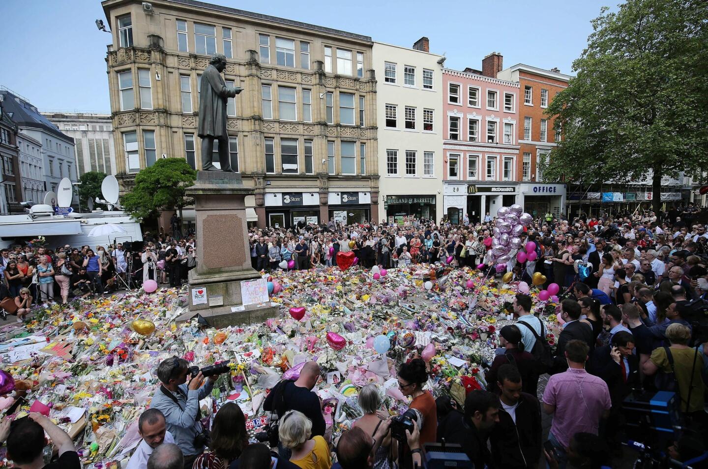 People pay their respects to the victims of the Manchester bombing with a nationwide minute of silence in St. Ann's Square on May 25, 2017.