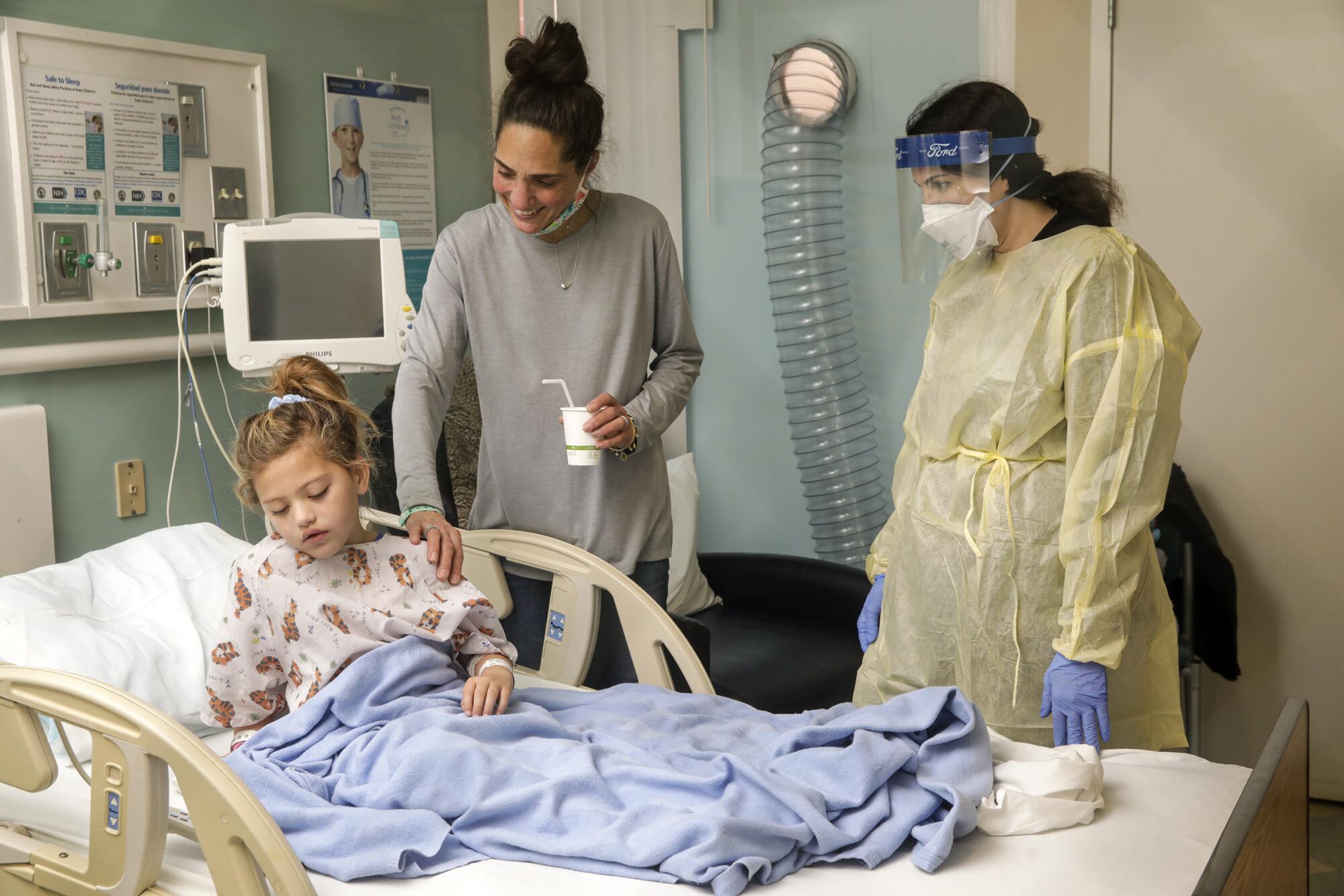 A family friend visits a 6-year-old COVID-19 patient.