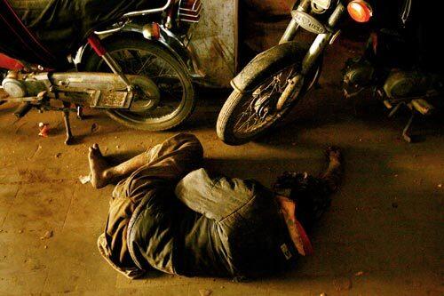 A man sleeps on the floor inside a central Karachi market in Pakistan. With a large chunk of the city's estimated 14 million people living in poverty, anti-government sentiment has been steadily growing. Although businesses reopened after a three-day mourning period for Benazir Bhutto, trade was light.