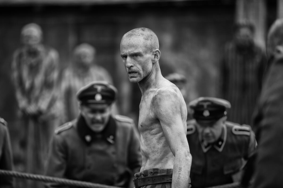 An emaciated prisoner boxes in a Nazi concentration camp in a scene from "The Survivor."