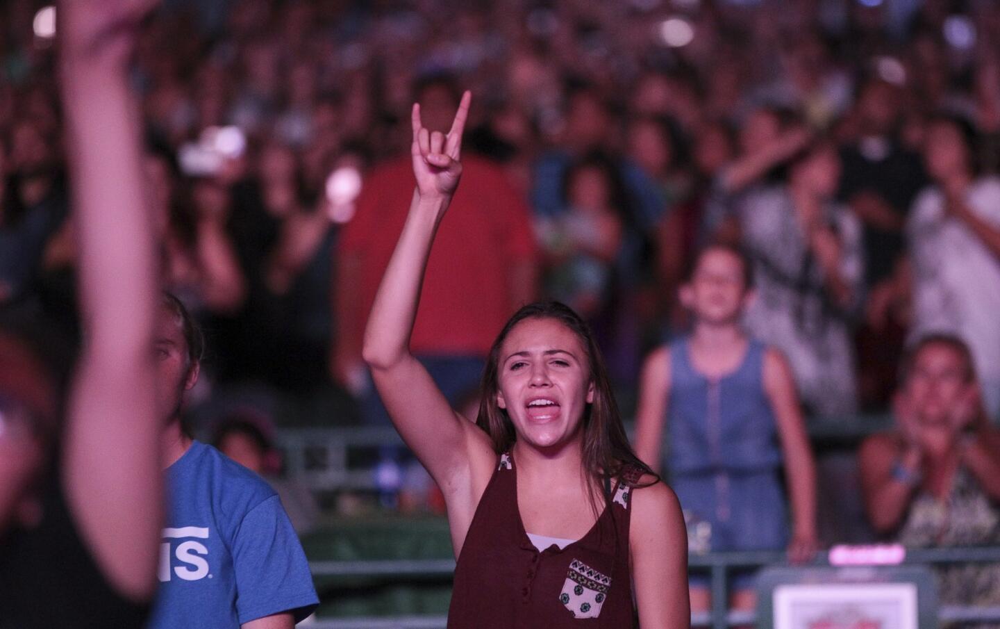 A fan sings along as Demi Lovato performs.