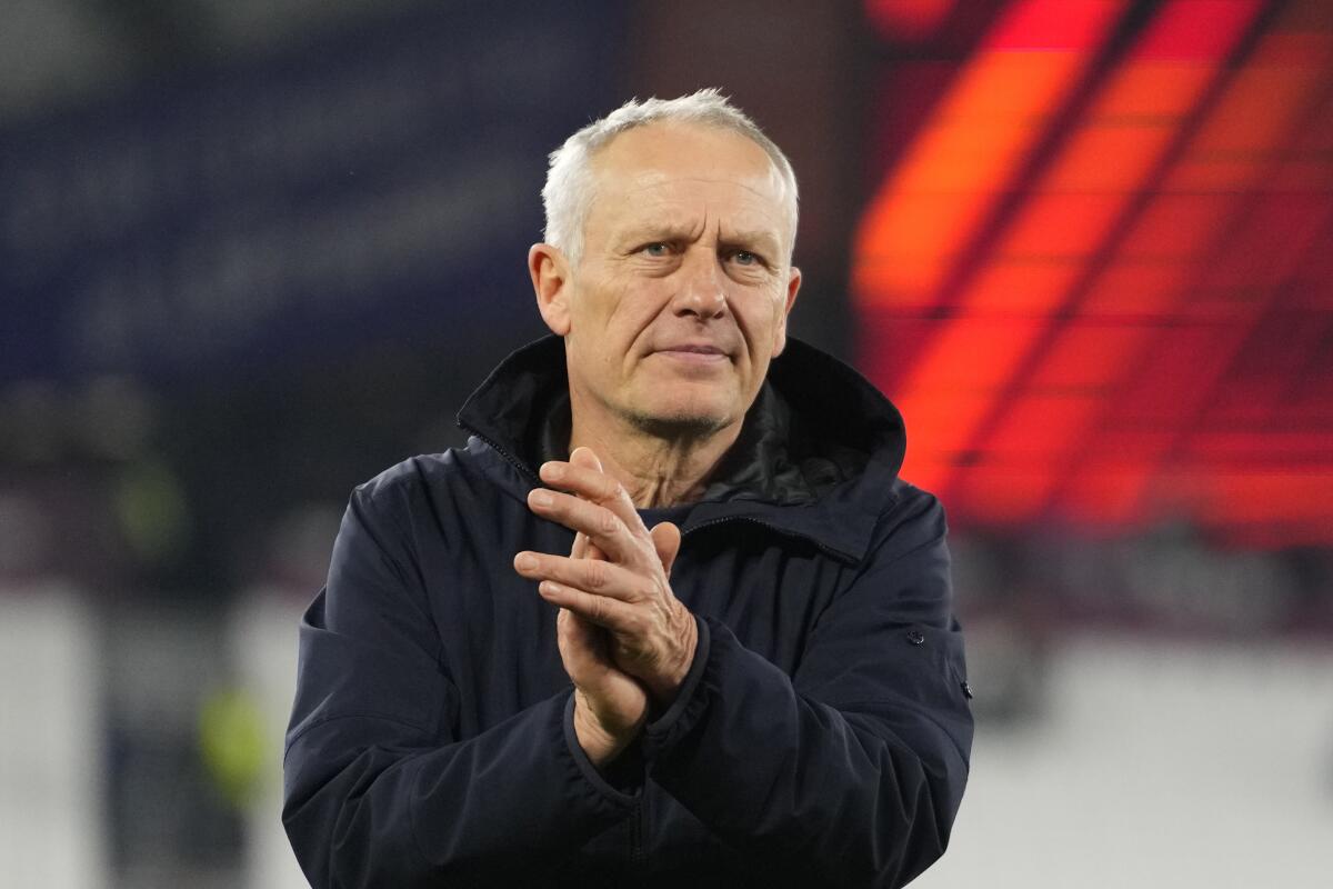 FILE - Freiburg's head coach Christian Streich applauds fans after the Europa League Group A soccer match between West Ham United and SC Freiburg at the London stadium in London, on Dec. 14, 2023. Freiburg coach Christian Streich has announced he will finally step down at the end of the season after more than 12 years in charge. It brings an end to a 29-year coaching association that started when he took over the under-19s in 1995. (AP Photo/Kirsty Wigglesworth, File)