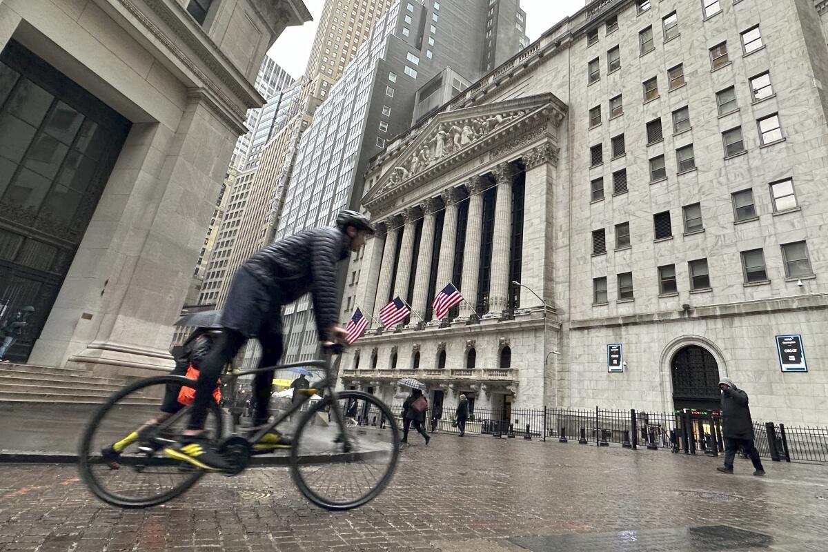 A bicyclist passes the New York Stock Exchange
