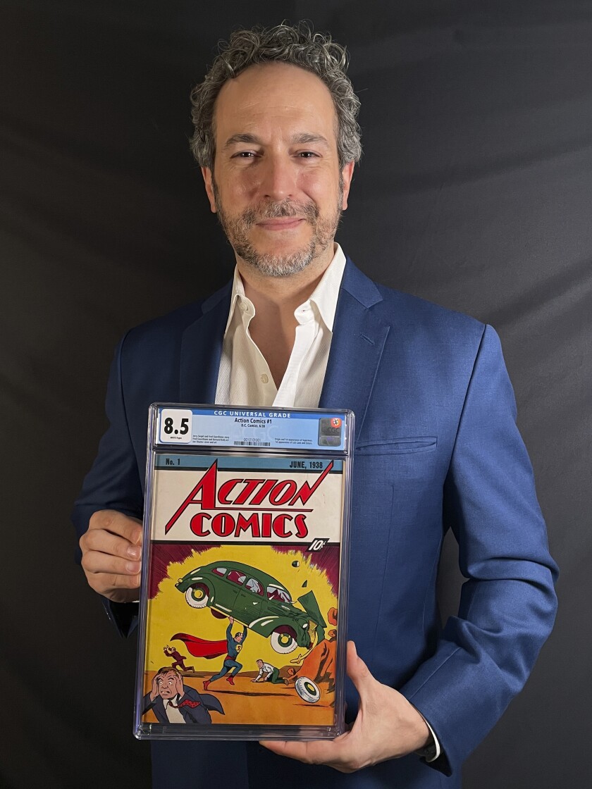 Man holding first edition of debut Superman comic book