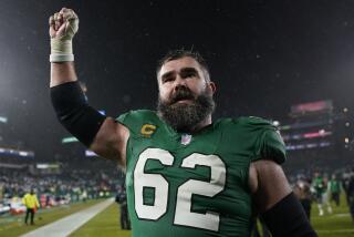 Philadelphia Eagles' Jason Kelce lifts his fist in the air while leaving the field after an NFL football game