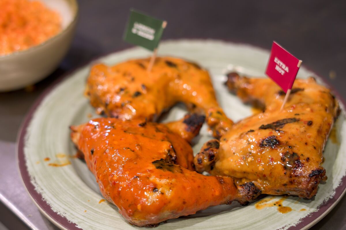 Pieces of cooked peri-peri chicken on a plate