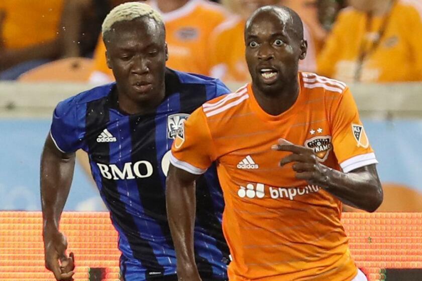 Houston Dynamo defender DaMarcus Beasley (7) looks up for a pass while Montreal Impact forward Ballou Jean-Yves Tabla (13) gives chase during the second half of an MLS soccer match Wednesday, July 5, 2017, in Houston. (Yi-Chin Lee/Houston Chronicle via AP)