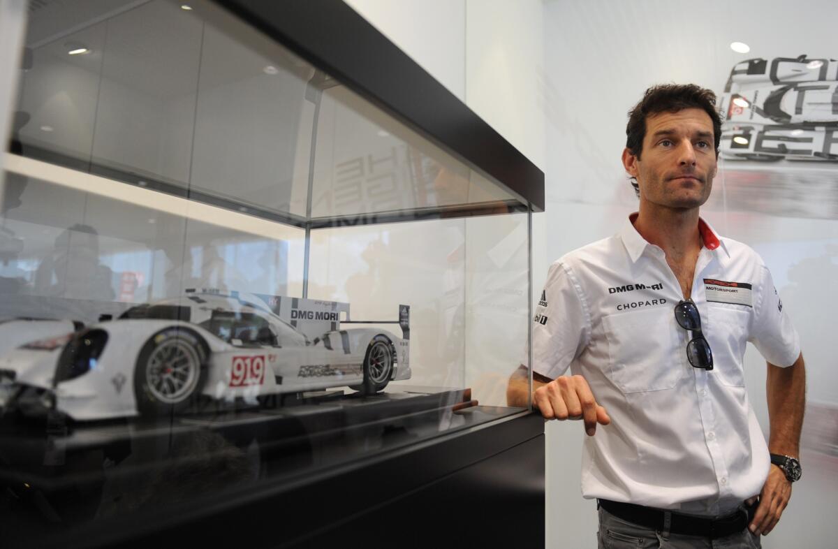 Australian pilot Mark Webber, driving a Porsche 911 Hybrid N20, poses after a news conference on June 13.