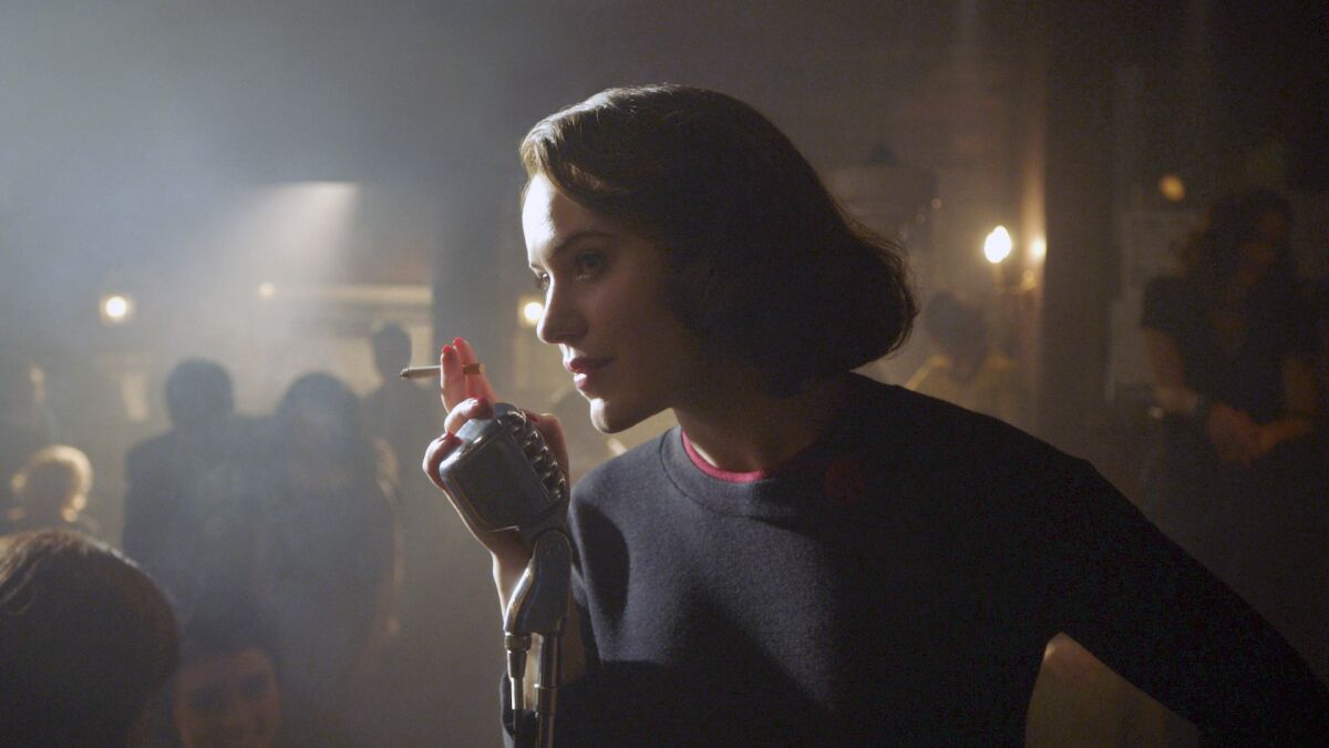 A woman leans toward a microphone in a smoky nightclub in 1960
