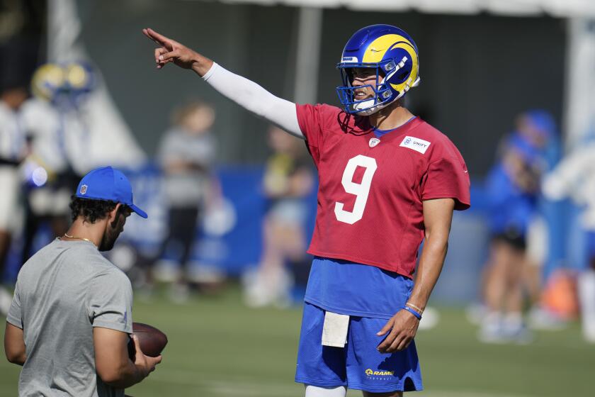 Los Angeles Rams quarterback Matthew Stafford signals during the NFL football team's training camp Wednesday, July 26, 2023, in Irvine, Calif. (AP Photo/Marcio Jose Sanchez)