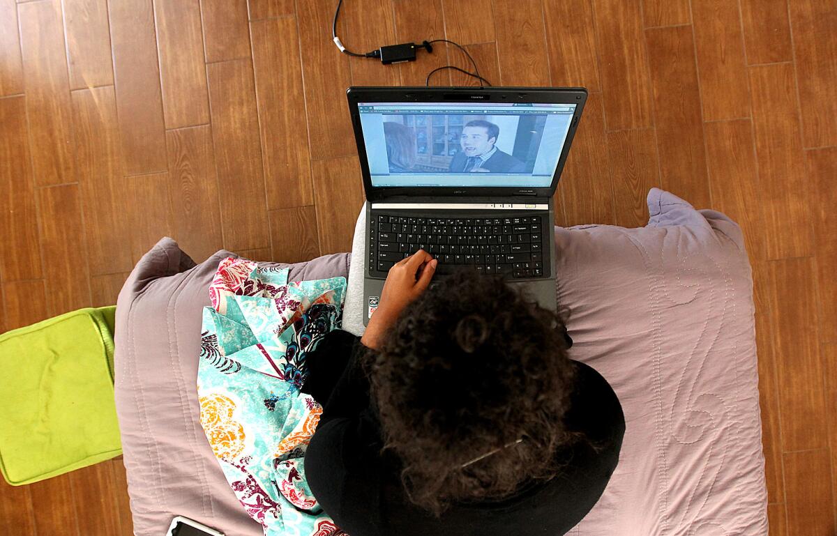 A USC student watches an episode of "Entourage" on her laptop in September 2010.