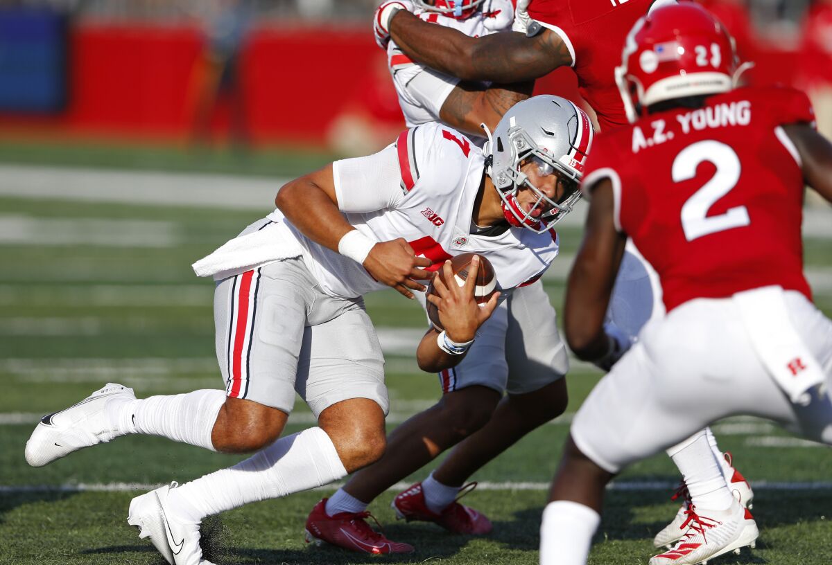 Ohio State quarterback C.J. Stroud (7) rushes against Rutgers defensive back Avery Young (2) during an NCAA college football game, Saturday, Oct. 2, 2021, in Piscataway, N.J (AP Photo/Noah K. Murray)