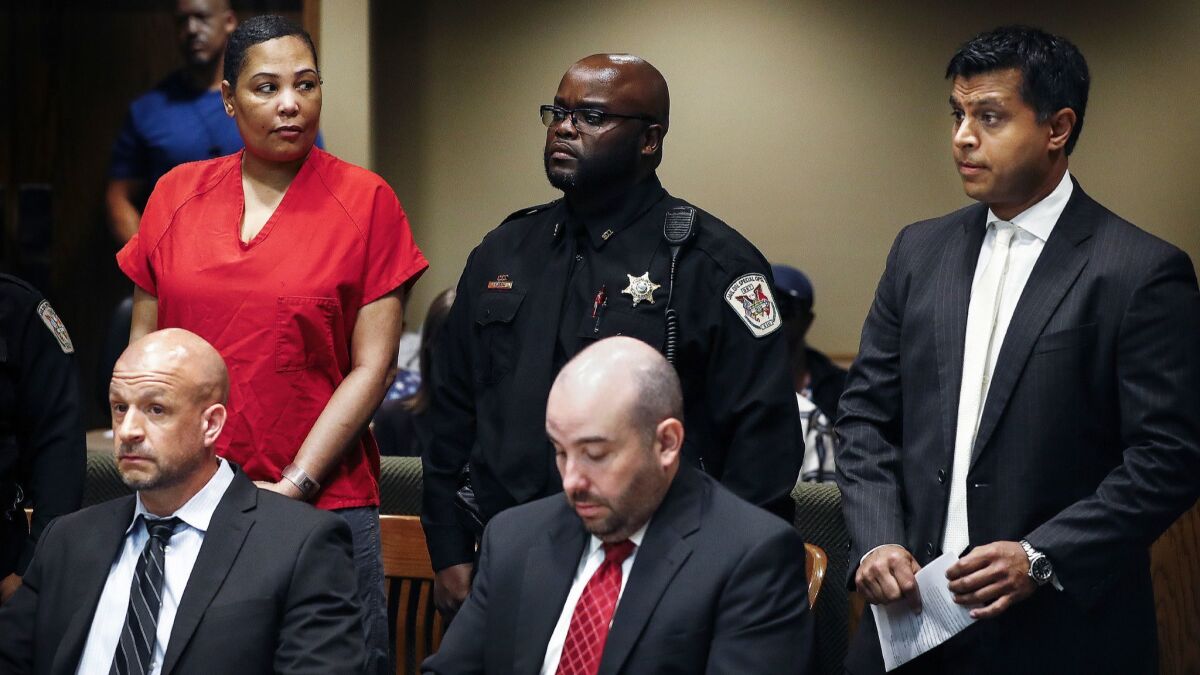 Sherra Wright, left, glances at attorney Juni Ganguli, right, after her lawyers Steve Farese and Blake Ballin asked to be withdrawn from representing her in Shelby County Criminal Court in Memphis on July 11.