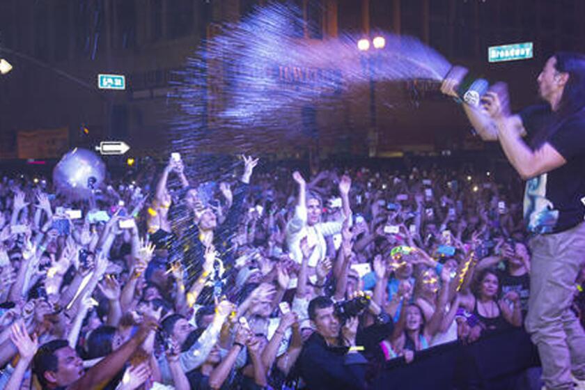 Steve Aoki sprays the crowd with sparkling wine during his free concert, titled "LAoki," in downtown Los Angeles on Saturday night.