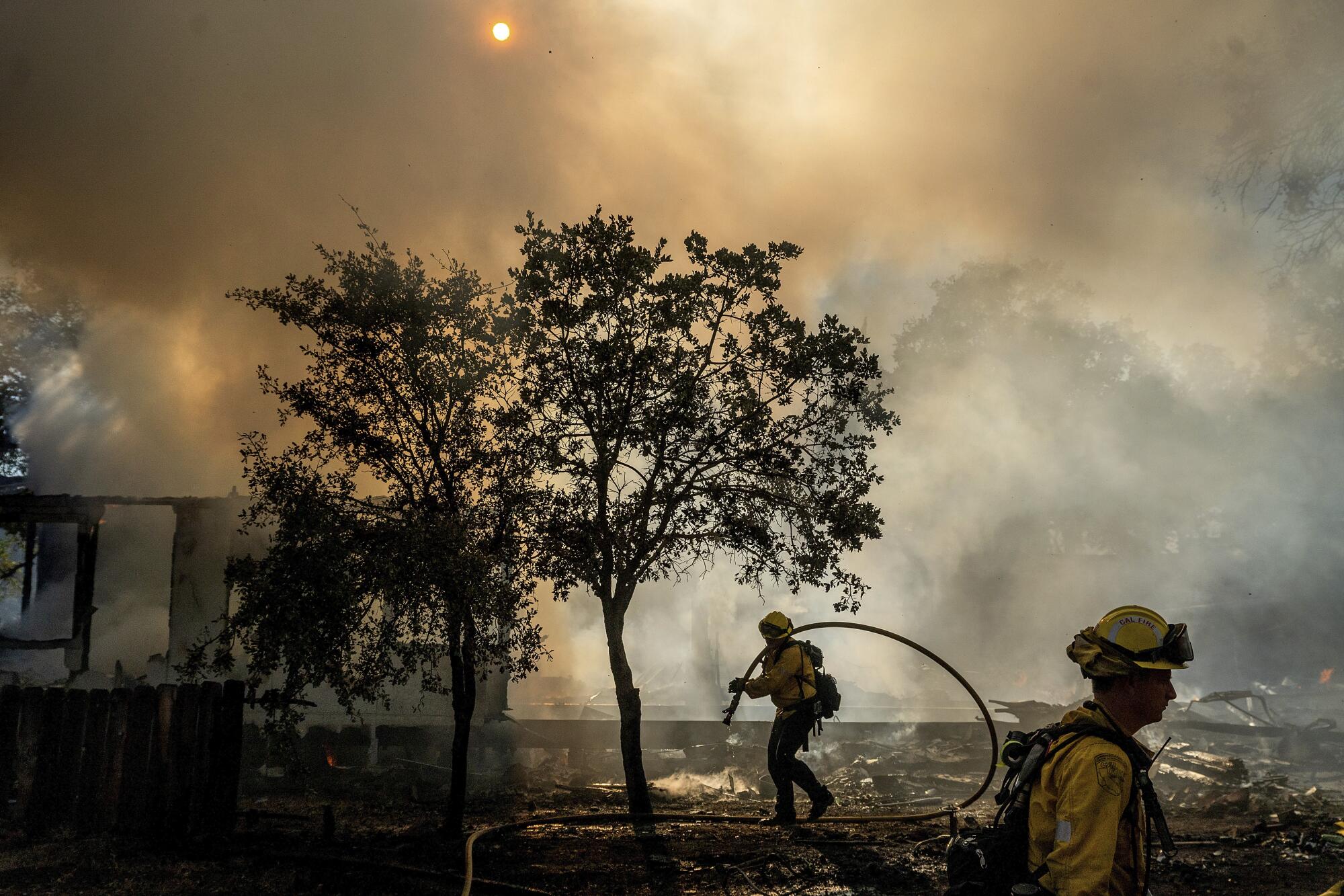 Firefighters battle the Boyles Fire in Clearlake, California, on Sunday.