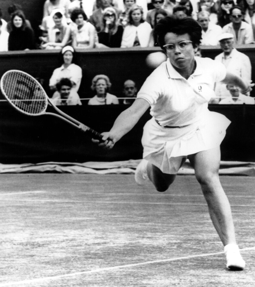 Billie Jean King hits a return during a fourth-round match at Wimbledon in 1968.