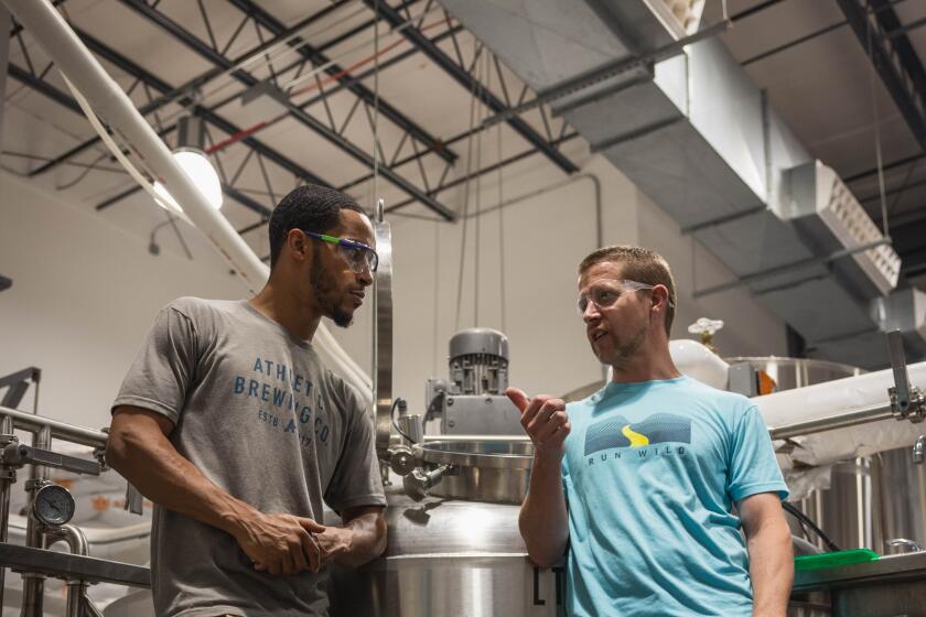 Athletic Brewing Company's 2021 scholarship winner Oren Ferris, left, with Athletic Brewing Company's co-founder and head brewer John Walker.