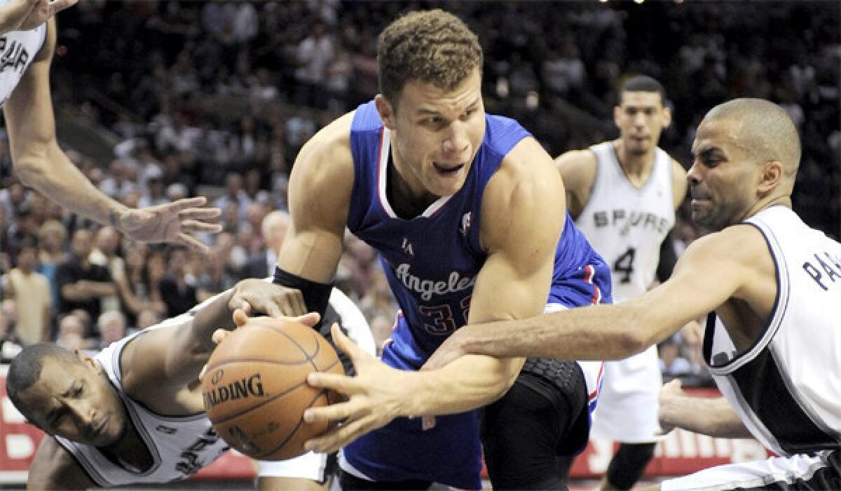 Blake Griffin chases a rebound between the Spurs' Tony Parker and Boris Diaw during the second half of the Clippers' 104-102 loss to San Antonio.