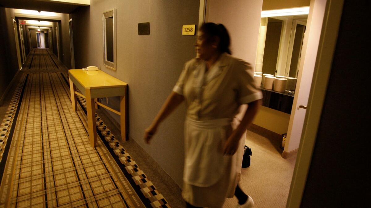 Maria Jimenez, a housekeeper, closes a door on the 12th floor of the Wilshire Grand Hotel.