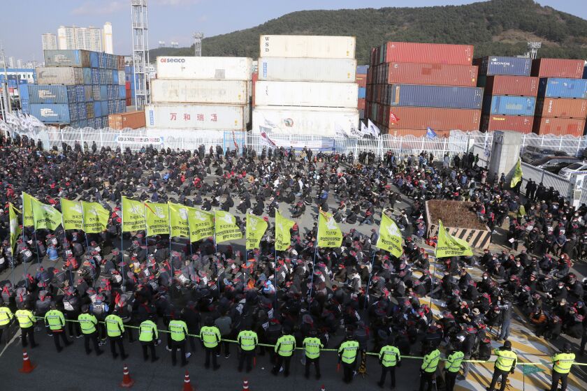 Members of the Korean Confederation of Trade Unions stage a rally to support the ongoing strike by truckers in Busan, South Korea, Tuesday, Dec. 6, 2022. (Gang Duck-chul/Yonhap via AP)