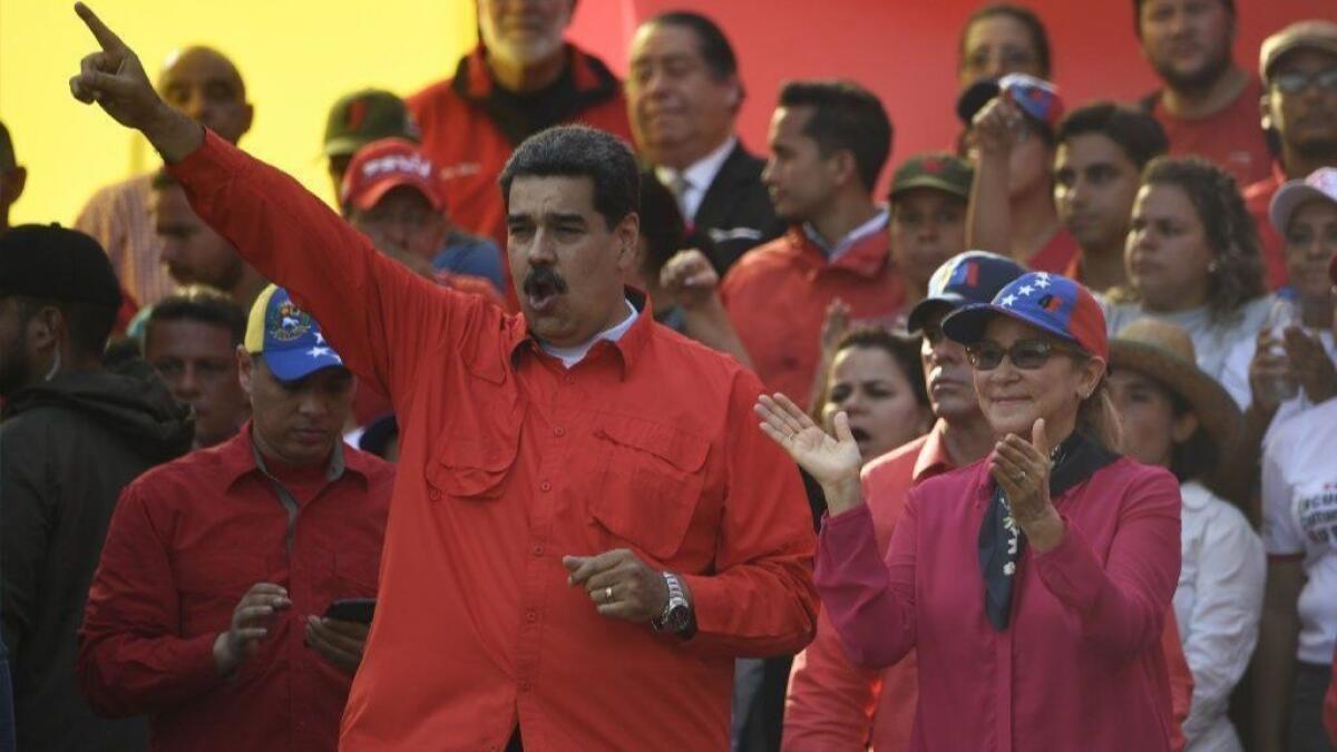 Venezuelan President Nicolas Maduro attends a May Day rally in Caracas with his wife Cilia Flores on May 1.